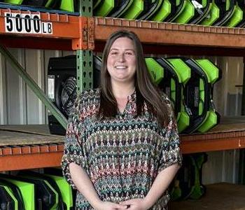 A Woman standing in front of a wall of air movers