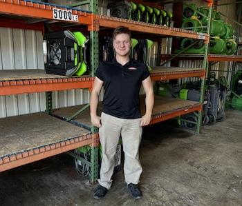 A Man standing in front of a wall of air mover fans