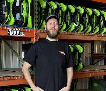 A Man standing in front of a wall of air mover fans