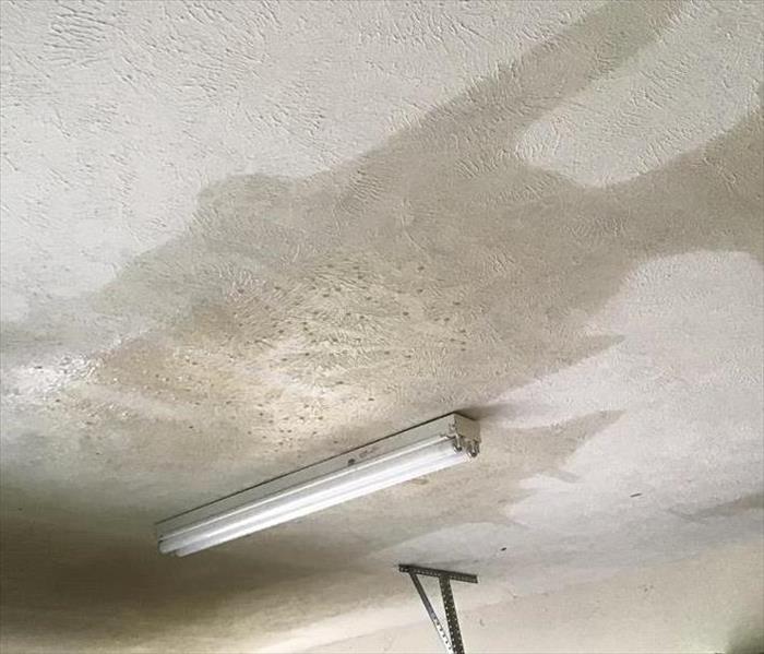 storm damaged ceiling with water spots